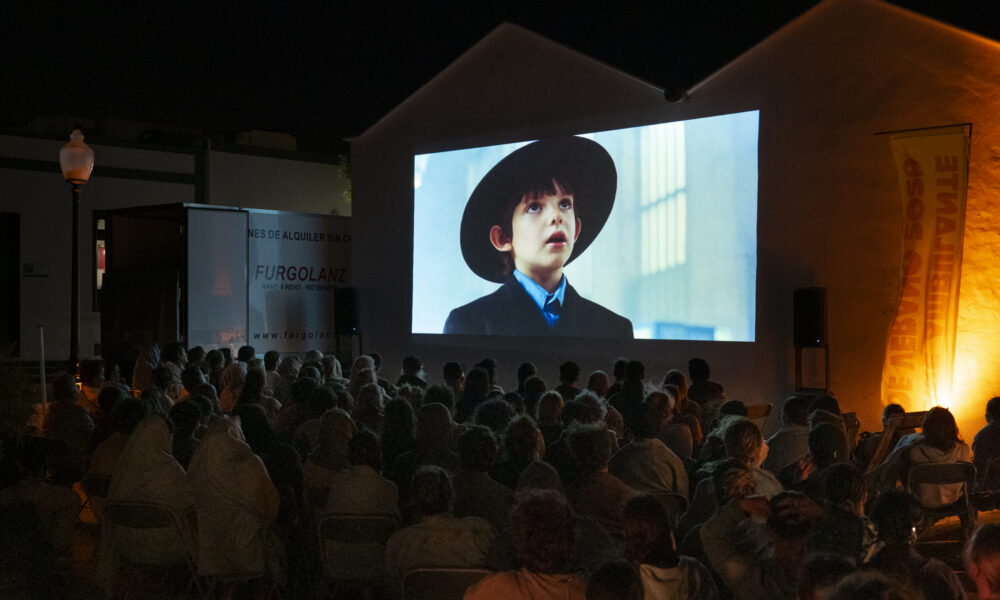 Espectadores disfrutando de una proyección del Cine Ambulante de Verano al aire libre en Lanzarote.